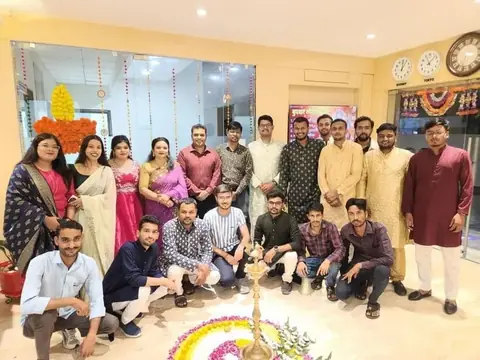 Team in the office lobby decorated with flowers and marigold garlands for Diwali