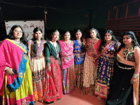 Women team members in colorful traditional Garba outfits at a Navratri celebration
