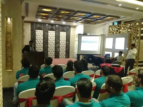Team members in matching Rays branded t-shirts attending a presentation at a company event