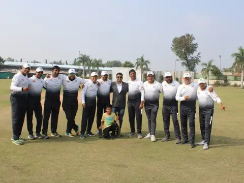 Rays EdTech cricket team posing together on the field in white and grey jerseys