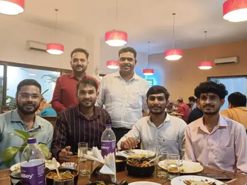 Team members enjoying a meal together at a restaurant