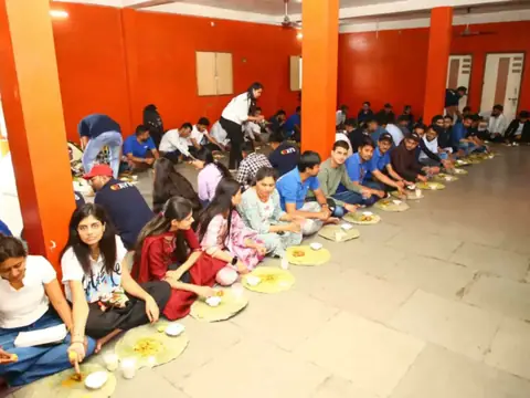 Large group of Rays EdTech team members seated in rows sharing a traditional meal on leaf plates
