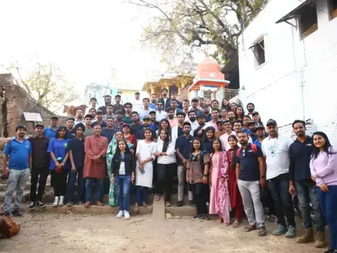 Large group photo of the team on a trip near a temple