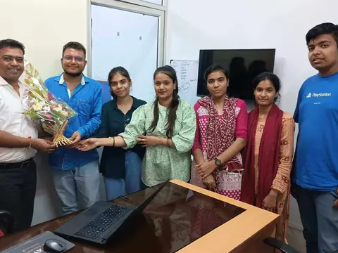 A team member being presented with a bouquet of flowers in the office