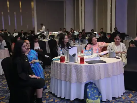 Attendees seated around banquet tables at the anniversary event