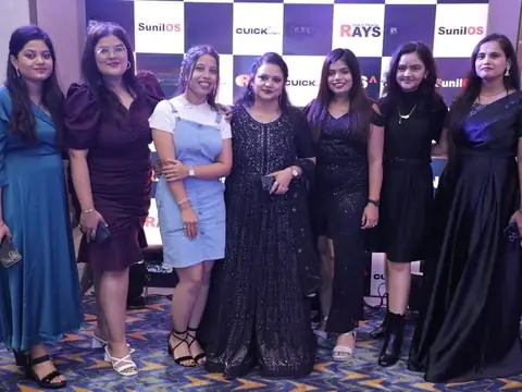 Group photo of women team members in front of the Rays EdTech and SunilOS backdrop at an event