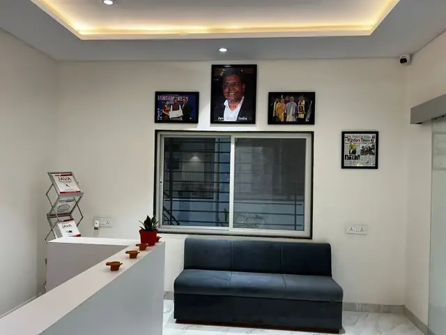 Waiting lounge near the Rays EdTech reception with a sofa and framed photos including a Java Man of India feature